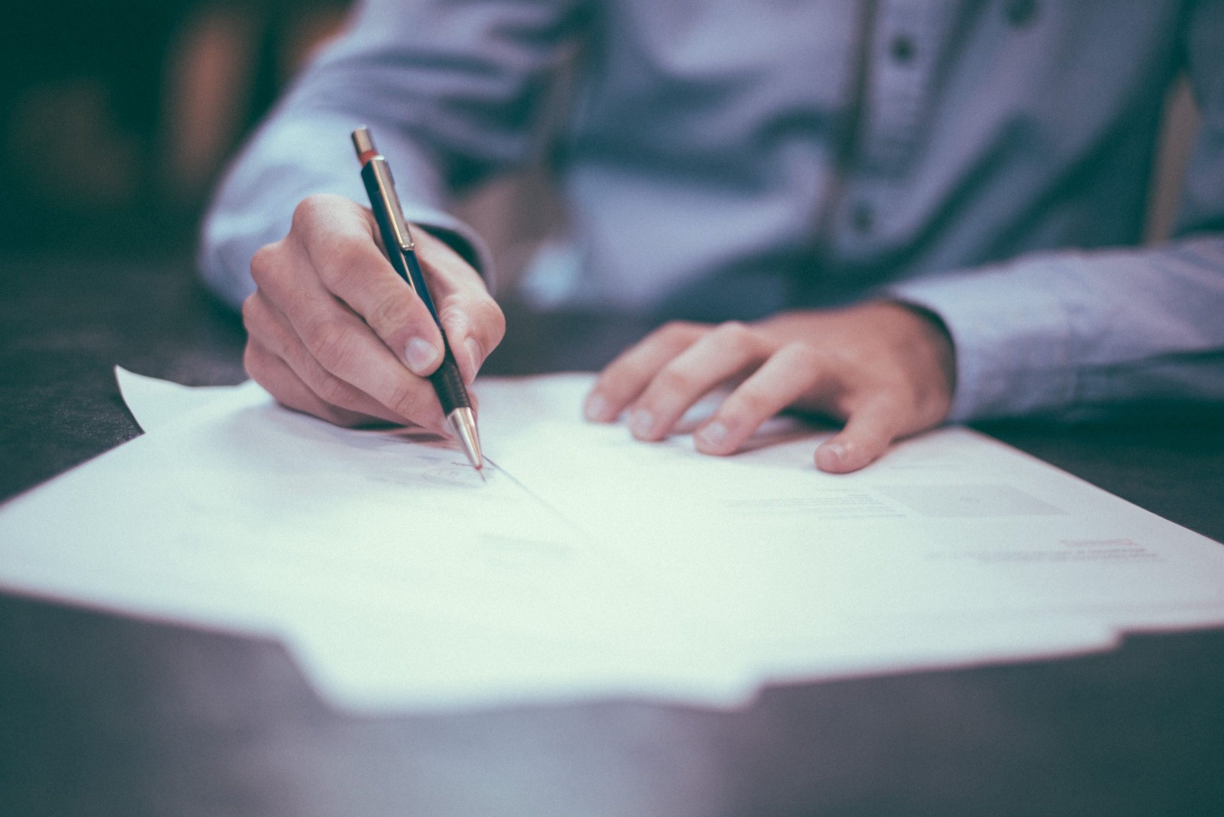A real estate closing in progress — documents being signed